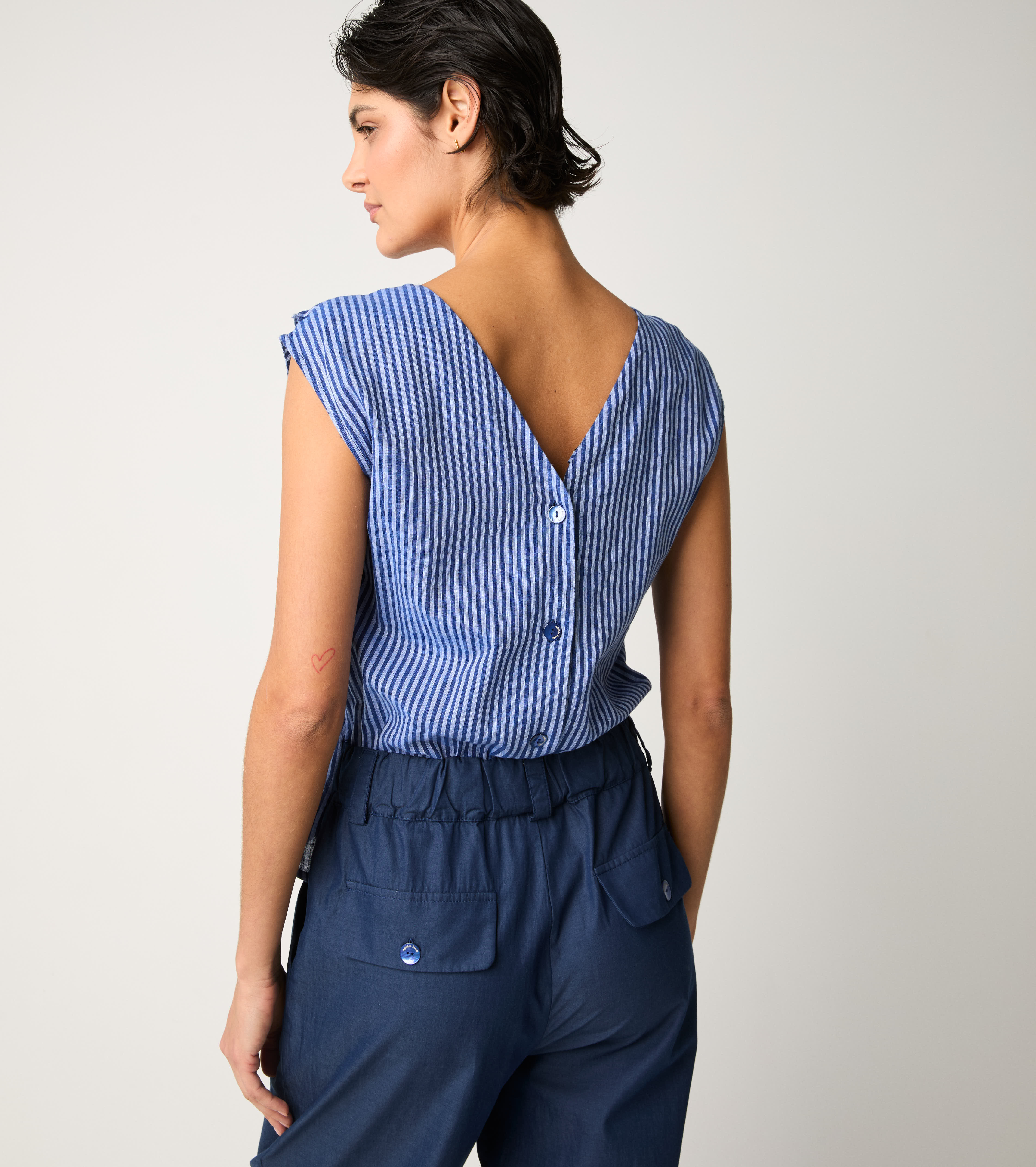 Striped jumpsuit with light blue ruffles